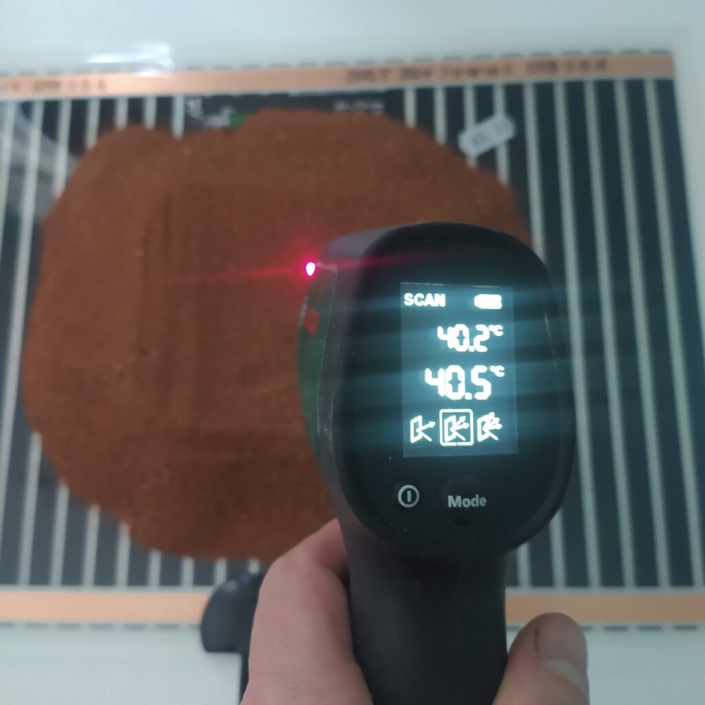 pomiar temperatury piasku leżącego na macie grzewczej